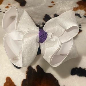 White glitter bow, with purple knot.
